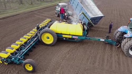 Blue tractor OA working on the field in Ukraine