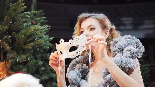 Woman Tries on a Masquerade Mask Before a Holiday Party