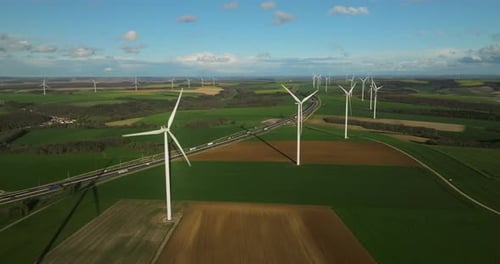 Aerial View of Wind Turbines in Green Fields