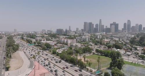 a highway with cars and buildings in the background