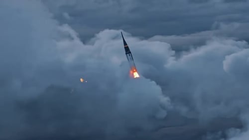 Powerful Rocket Launching Through Clouds with Fiery Boost