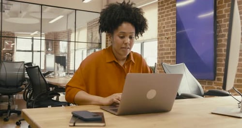 Black Young Adult Businesswoman Working on Laptop in Office