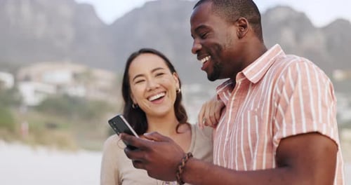 Smile, beach and couple checking phone on romantic date, weekend and relax together with online
