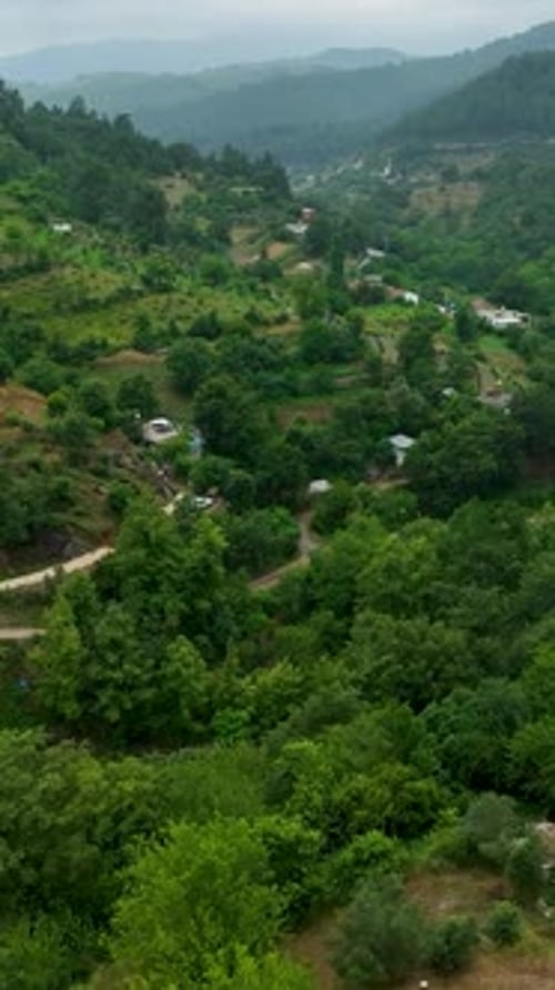 Vertical Video Aerial Rain Discovering a Rural Mountain Village