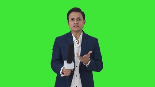 Indian reporter asking questions to someone Green screen
