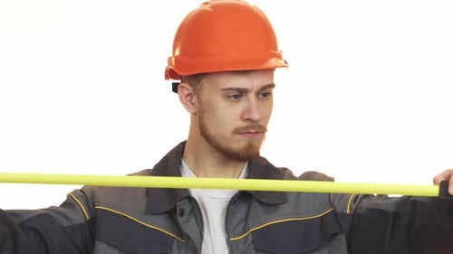 Focused Young Male Engineer Measuring with Precision
