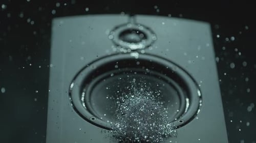 Silver Glitter Falling on a Black Speaker