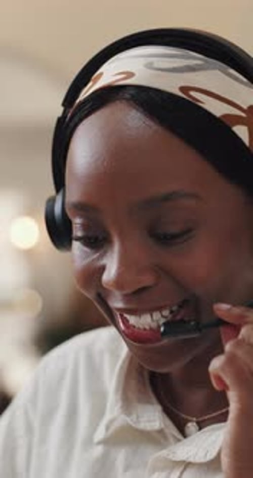 Smiling Woman with Headset Speaking into Microphone