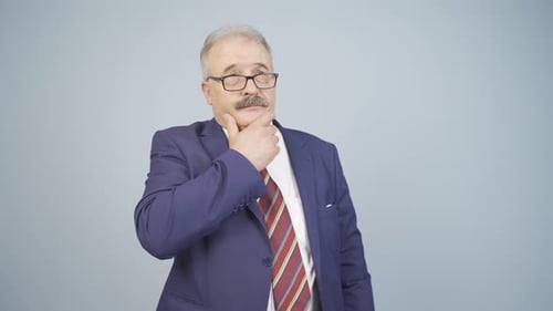Man in Suit Thinks and Crosses Arms