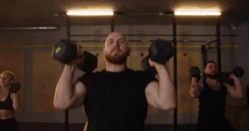 Adults Lifting Weights in an Indoor Gym