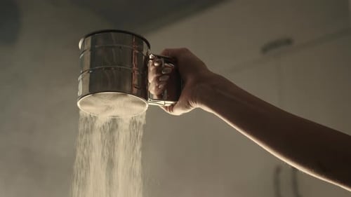 Closeup Slowmotion of Woman is Sifting Flour Through a Sifter