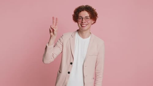 Smiling Young Adult Giving Peace Sign