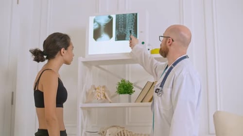 Doctor Explains Spinal X-Ray to Patient