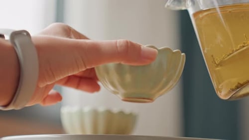 Close Up of Tea Pouring Into Small Bowl