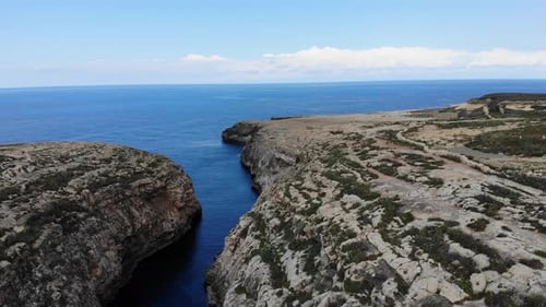 Hidden beach cove valley in Malta, Ghasri, Gozo mediterranean island wide view of sea on clear summe