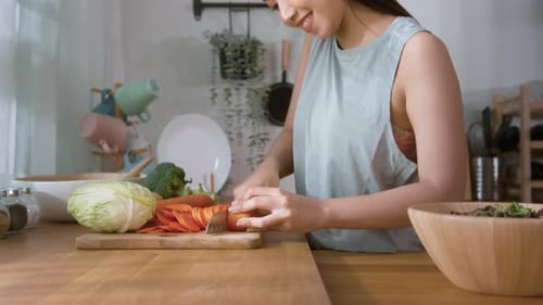 Young Woman Preparing Healthy Salad in Kitchen