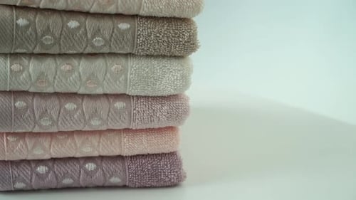 Close Up of Stack of Cotton Terry Folded Towels Rotate on Board