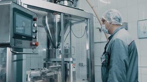 Machine operator working on pharmaceutical production line