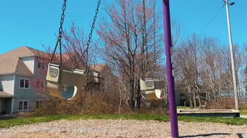 Empty Swing on a Sunny Spring Day Children's Playground