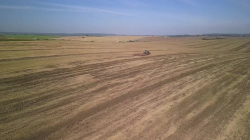 Tractor working on the field doing tillage with cultivator