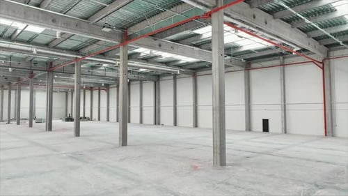 Footage of White Huge Modern Logistics Warehouse Indoors Camera Moving Around Empty Industrial Space
