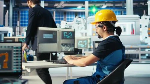 Solar Panels Manufacturing Plant Technician Designing Conveyor Belts on PC