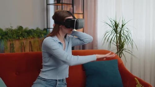 Woman Using Virtual Reality Headset on Sofa