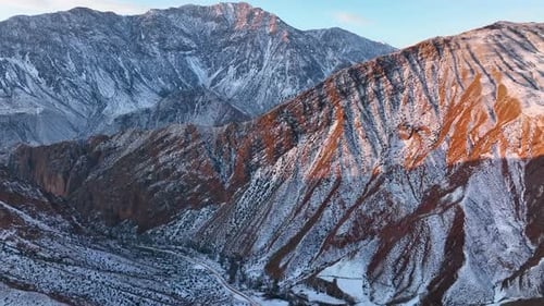 Snowy Mountains and Valleys at Sunrise