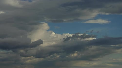 Dramatic Cloudscape with Billowing Gray Clouds in Blue Sky