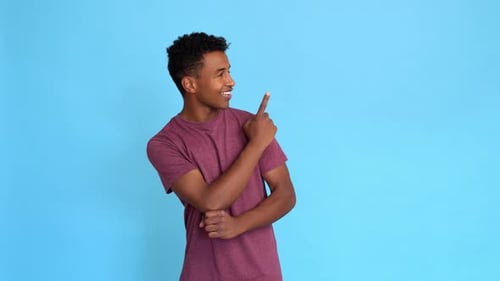 Young Man Pointing His Finger to the Side
