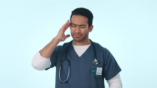 Asian man, doctor and headache in stress, burnout or mental health against a studio background