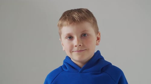 Portrait of Happy Smiling Boy in Blue Tshirt Attractive Kid in Studio Over Grey