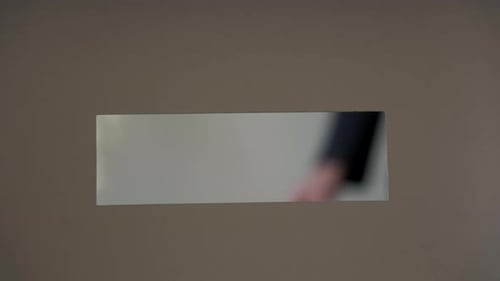 Close Up Shot of Person Casts Her Ballot During Voting for Elections at a Polling Station