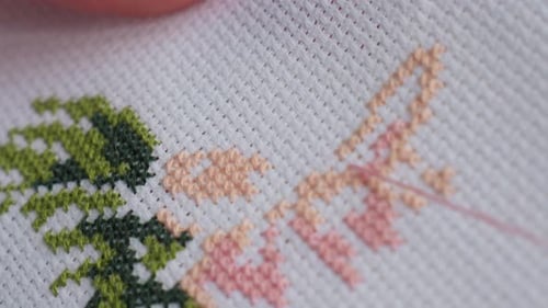 Extreme Close Up of Skilled Person Embroidering Colorful Fabric Design