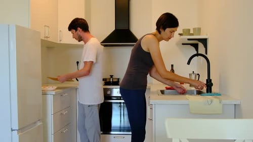 Man and woman preparing food in modern kitchen