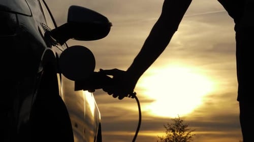 Electric Car Unplugged at Sunset Golden Hour