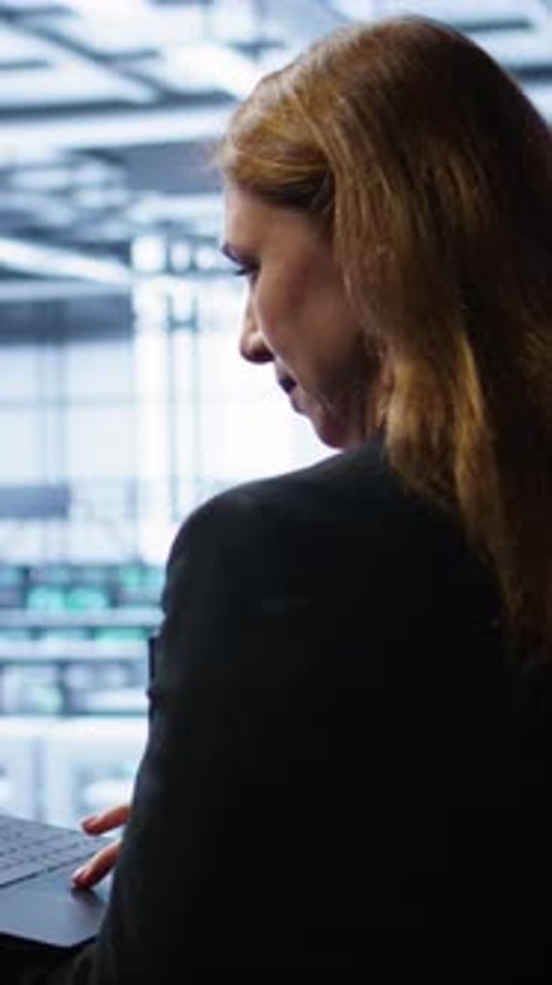 Vertical Video System Administrator in Data Center Running Error Checking Utilities on Laptop