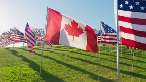 American and Canadian Flags Waving in the Breeze
