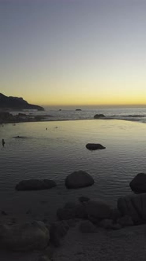 Cinematic Panning Shot of Popular Camps Bay Tidal Pool. Cape Town, South Africa. Sunset Golden Hour