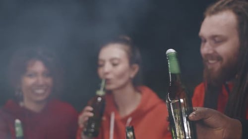 Friends Drinking Bottled Drinks at Night