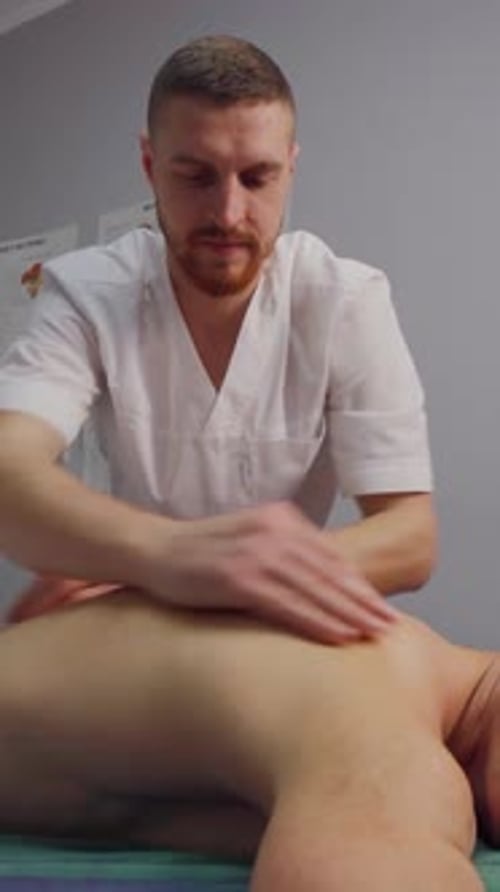 Massage Therapist Massaging Patient in Medical Setting