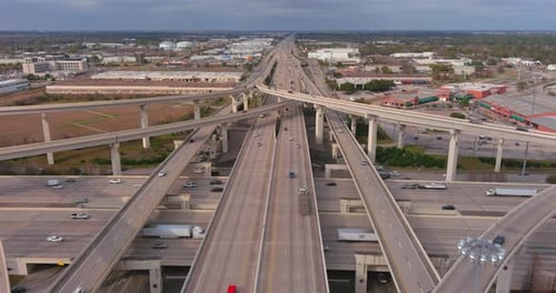Aerial View of Modern Multi Level Highway Interchange and Urban Traffic