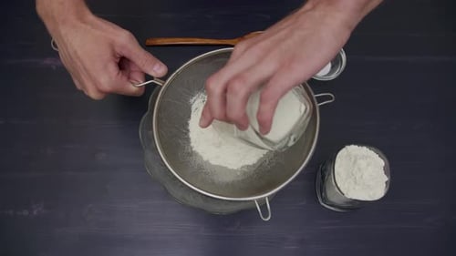 Flour Sifting Through a Sieve for a Baking Chef Man Top View