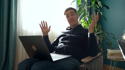 Enthusiastic Young Adult Video Calling On Laptop