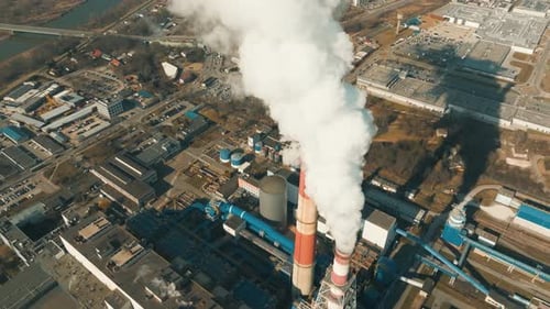 Heavy smoke rises from a coal power plant chimney.