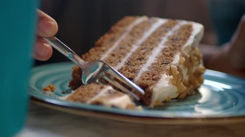 Person Use Fork Eating a Caramel Cake on Cafe