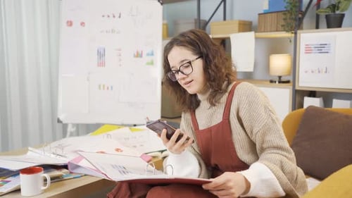 Cheerful Woman Working From Home With Smartphone