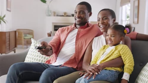 African American Family Watching Tv Together. Happy Mature Father Changing Television Channel Usi...
