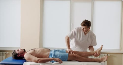 Osteopath Treating Male Patient in Clinic