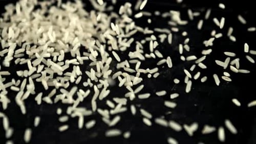 A Pile of Uncooked Rice Falls on the Table Filmed is Slow Motion 1000 Fps